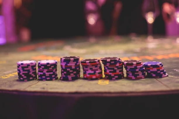 Dealer at a baccarat table with multiple camera angles